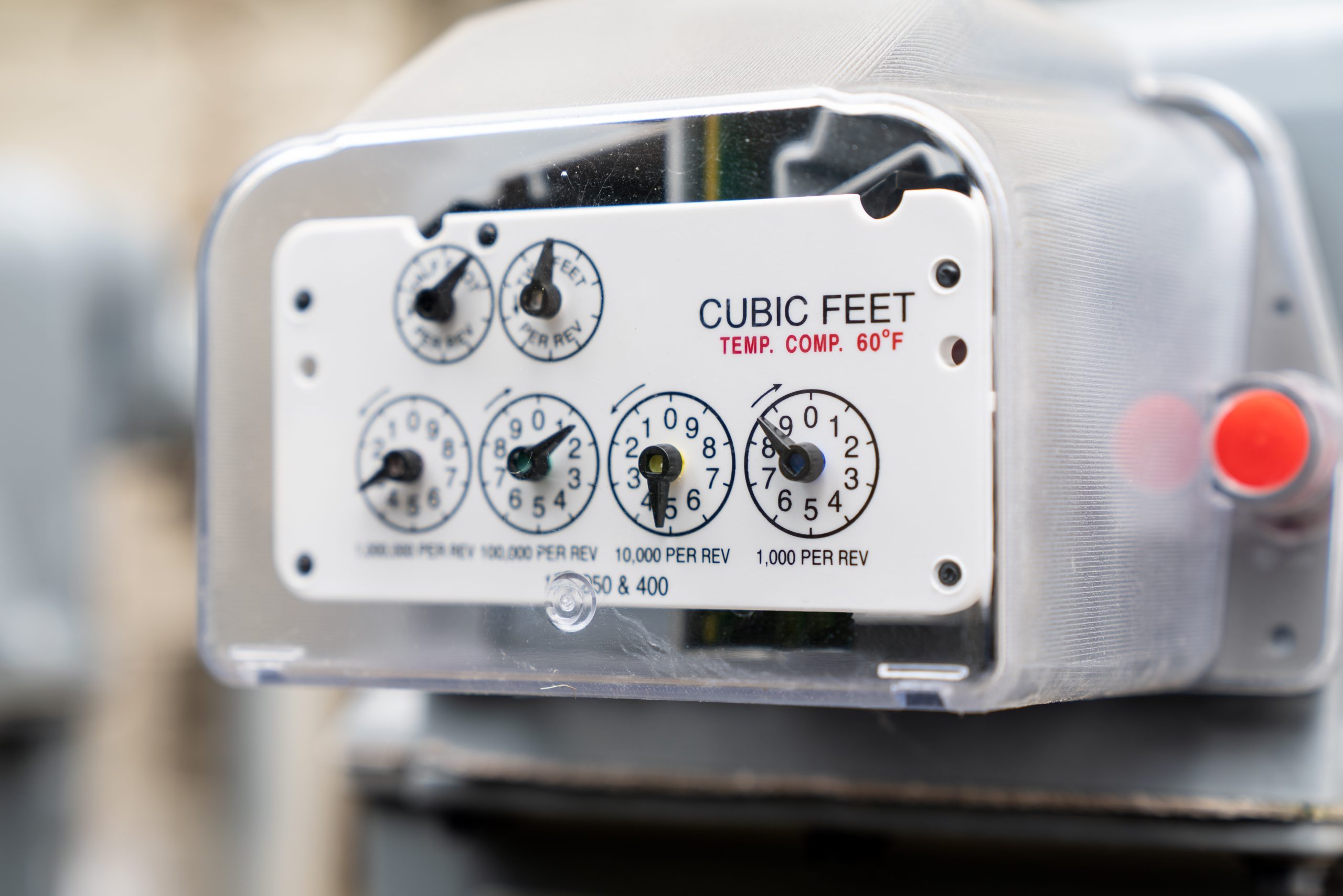 Row of gray natural gas meters at an apartment complex